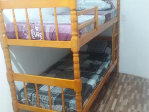 a bunk bed in a room with a bunk bed frame at Pousada Recanto do Coruja in São Gabriel