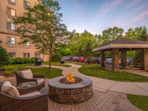a fire pit in a park with chairs and a building at Staybridge Suites Milwaukee Airport South, an IHG Hotel in Franklin