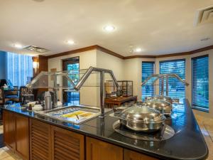 a kitchen with several pots and pans on a counter at Staybridge Suites Milwaukee Airport South, an IHG Hotel in Franklin