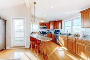 a kitchen with wooden cabinets and a large island at Sunset View in Wells