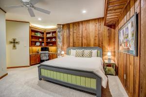 a bedroom with a bed and wooden walls at Stone Lodge in Spicewood