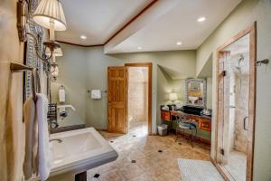 a bathroom with a tub and a sink at Stone Lodge in Spicewood +51 photos