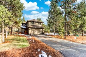 a house on a road in the woods at Lost Rider Loop Lodge in Sunriver