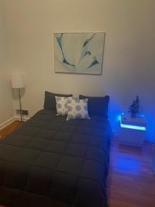 a bedroom with a bed with a blue light at A Cozy Home Away From Home in Washington