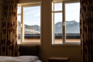 a bedroom window with a view of a mountain at Scandic Byparken in Bergen