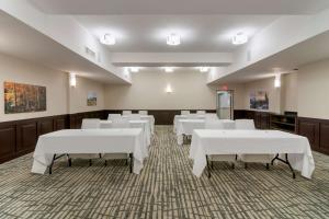 a conference room with white tables and white chairs at Best Western Premier Aberdeen Kamloops in Kamloops