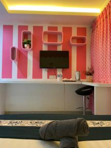 a person laying on the floor in a room with a desk at Dolphin Hotel in Klang