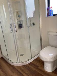 a bathroom with a shower and a toilet at Country Retreats On Ranzau 4 in Hope