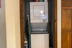 a refrigerator in a small room with a washer and dryer at Summertime III in Bar Harbor