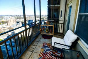 a balcony with a chair and a table on a building at Modern Designed DTWN Condo with a 99 percent Walk Score in Atlanta