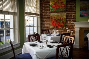 a dining room with a table with white table cloth at The Marshall House, Historic Inns of Savannah Collection in Savannah