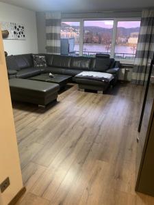 a living room with a couch and a large window at Ferienwohnung Vanessa in Remagen