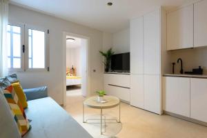 a living room with a couch and a table at Canteras Urban Beach in Las Palmas de Gran Canaria