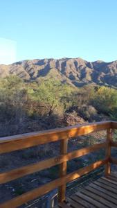 a wooden fence with a view of a mountain at Complejo Puesta del Sol san Luis in La Punta