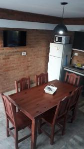 a wooden table and chairs in a kitchen at Complejo Puesta del Sol san Luis in La Punta