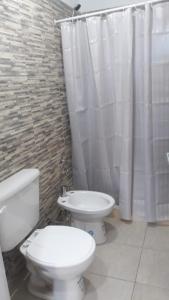 a bathroom with a toilet and a sink at Complejo Puesta del Sol san Luis in La Punta