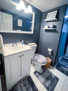 a bathroom with a sink and a toilet and a mirror at Modern Designed DTWN Condo with a 99 percent Walk Score in Atlanta