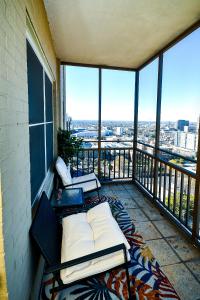 a balcony with a bed and a view of the city at Modern Designed DTWN Condo with a 99 percent Walk Score in Atlanta