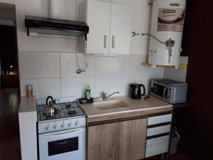 a small kitchen with a sink and a stove at alquilerpordiviedma in Viedma