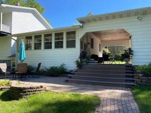 a house with a porch and a patio at Breezeway Bay - Waterfront Full House in Wisconsin Dells
