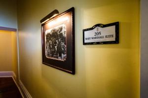 a picture on a wall with a sign on it at The Marshall House, Historic Inns of Savannah Collection in Savannah