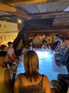 un grupo de personas sentadas en una piscina en Chinatown Hostel by Mingle en Kuala Lumpur