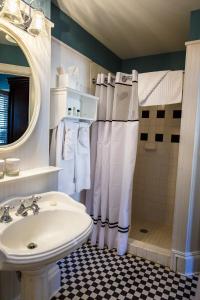 a bathroom with a sink and a shower at The Marshall House, Historic Inns of Savannah Collection in Savannah