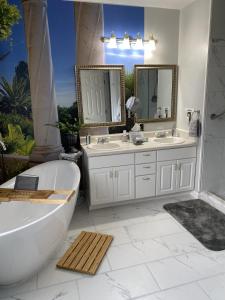 a bathroom with two sinks and a bath tub and a tub at Page House Bed & Breakfast in Dublin