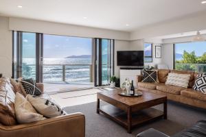 a living room with a couch and a table at The Big Bach in Wellington