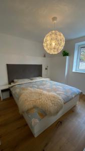 1 dormitorio con cama y lámpara de araña en Happy Amadei, en Sankt Veit im Pongau
