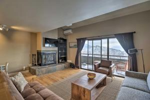 a living room with a couch and a fireplace at Whitefish Mtn Ski-in and Out Condo Steps to Slopes! in Whitefish