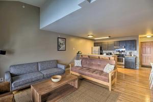 a living room with a couch and a table at Whitefish Mtn Ski-in and Out Condo Steps to Slopes! in Whitefish