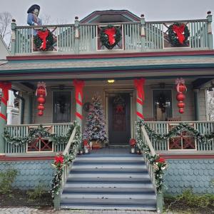 un árbol de Navidad en el porche delantero de una casa en New Listing ! Captain's Cottage - Cold Spring Harbor Water Views, 