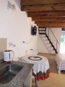 a kitchen with a sink and a staircase in a room at La Yuma en Villars in Villars