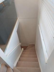 a staircase in a room with a stair case at 1 bedroom modern duplex in Southampton