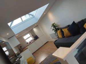 a living room with a black couch in a loft at 1 bedroom modern duplex in Southampton