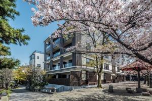 a building with aakura tree in front of it at Hotel Alza Kyoto in Kyoto