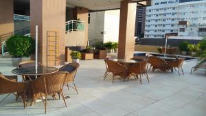 un patio con mesas y sillas en un edificio en Flat na Beira Mar Mucuripe, en Fortaleza