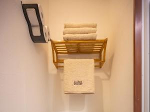 a towel rack with towels in a bathroom at Lodge Scole in Zaō Onsen