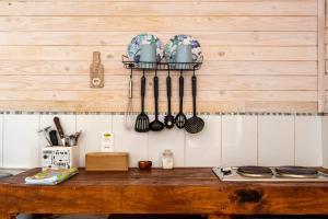 a wooden table with utensils on a wall at Pichilemu Apart Hotel in Pichilemu