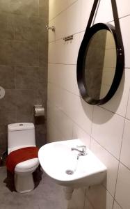 a bathroom with a toilet and a sink and a mirror at Sovotel @ USJ 9 in Subang Jaya