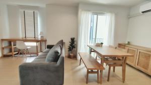 a living room with a couch and a table at Cozy 1-bedroom condo close to MRT near JJ market in Bang Su