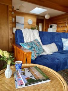 sala de estar con sofá azul y mesa en Spring Beach Retreat, en Spring Beach