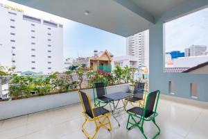 a balcony with a table and chairs and a view of the city at Villa Vũng Tàu - An Thảo Home's in Vung Tau