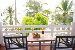 a table with a bowl of fruit on a balcony at DYNASTY MUINE RESORT in Ấp Thiện Phước