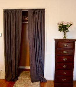 a door with a curtain next to a dresser at The Hi Point Estate in Los Angeles