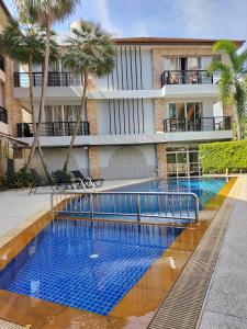 a swimming pool in front of a building at La Piccola Kata in Kata Beach