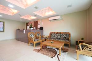 a living room with a couch and chairs and a table at Mawar Villa, Batu Hitam in Kuantan