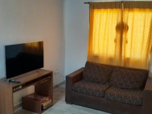 a living room with a couch and a television at Mendoza, Cacheuta, montaña in Ciudad Lujan de Cuyo