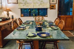 a dining room table with blue dishes on it at Gorayya Villa in Dehradun